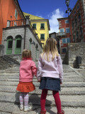 Two Girls on Ulica 1 Maja Street with Colourful Buildings Photographic Print by Ruth Eastham & Max Paoli