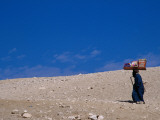 Food and Drink Vendor Carrying Goods in Desert around Giza Photographic Print by Russell Mountford