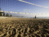 Person Jogging Near Volleyball Net on Manly Beach, Early Morning Photographic Print by Oliver Strewe