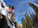 Skier Jumping Off Small Cliff at Brighton Ski Resort Fotoprint van Paul Kennedy
