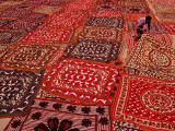 Worker Spreading Out Block Printed Cloth to Dry on River Bank. Photographic Print by Richard l'Anson