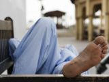 Man Resting on Park Bench in Bur Dubai Photographic Print by Brent Winebrenner