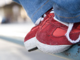 Red Tennis Shoes on Railing Photographic Print by Sabrina Dalbesio