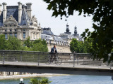 Cyclist on Passerelle Leopold Sangor Photographic Print by Lou Jones