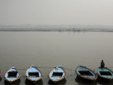 Rowboats Lining Shore of Ganges Photographic Print by April Maciborka