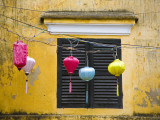 Lanterns Hanging Besides Bright Yellow Wall Photographic Print by Tony Burns