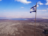 The Blue and White Flag of Israel, the Star of David Flies over the Deserts of Masad Photographic Print by Russell Mountford