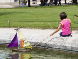 Girl with Toy Boat in Pond of Jardin Des Tuileres Photographic Print by Lou Jones