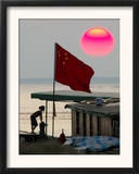 A Girl Rests on a Boat Below the Chinese National Flag Framed Photographic Print