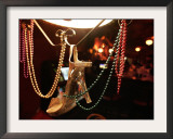 A Woman's High Heeled Shoe Hangs with Some Mardi Gras Beads Framed Photographic Print
