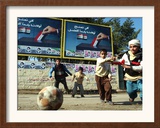 Iraqi Boys Play Soccer Below the Poster Reading "To Grant Iraqi Children Better Iraq" Framed Photographic Print