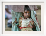 A Displaced Tamil Child Hangs to Her Father's Sarong Framed Photographic Print by Gemunu Amarasinghe