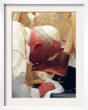 Pope John Paul II Kisses the Foot of a Clergyman Framed Photographic Print
