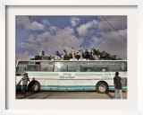 Palestinians Sit on Top of a Bus Framed Photographic Print