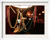 A Woman's High Heeled Shoe Hangs with Some Mardi Gras Beads Framed Photographic Print