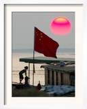 A Girl Rests on a Boat Below the Chinese National Flag Framed Photographic Print