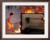 Bahraini Child Plays Near to Burning Tires and a Dumpster Framed Photographic Print