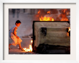 Bahraini Child Plays Near to Burning Tires and a Dumpster Framed Photographic Print