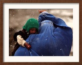 An Afghan Woman Holding Her Child Throws Back Her Burqa to See Her Way Along a Muddy Alley Framed Photographic Print