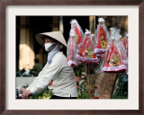 A Vietnamese Vendor Rides Downs a Hanoi City Street Selling Santa Hats Framed Photographic Print