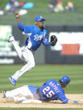 Kansas City Royals v Texas Rangers, SURPISE, AZ - FEBRUARY 27: Alcides Escobar and Mike Napoli Photographic Print by Rob Tringali