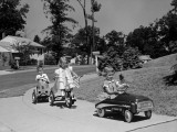 Boy and Two Girls on Suburban Sidewalk, Riding Tricycle and Toy Cars Photographie par H. Armstrong Roberts