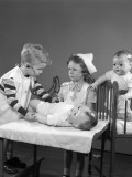 Boy and Girl Playing Doctor and Nurse Using Doll As a Patient Photographie par H. Armstrong Roberts