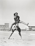 Couple Playing Leapfrog on Beach, Woman Jumping Over Man Fotografie-Druck von H. Armstrong Roberts