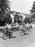 Group of Seven Children Riding Bicycles Along Suburban Street Photographic Print by H. Armstrong Roberts