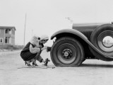 Woman Changing Flat Tire on Car Fotografie-Druck von H. Armstrong Roberts