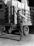 Truck Driver Dressed in Overalls Resting Foot on Cab of Truck Photographic Print by H. Armstrong Roberts