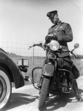 Policeman on a Motorcycle Writing a Ticket Photographie par H. Armstrong Roberts