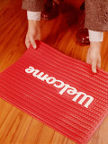 Man's Hands Laying Down Welcome Mat Photographic Print by H. Armstrong Roberts