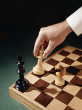 Hand Moving Chess Piece in Chess Game Checkmate Photographic Print by H. Armstrong Roberts