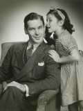 Daughter (8-9) Whispering Into Father's Ear Photographie par George Marks