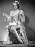 Woman in Night Gown Holding Stockings Photographic Print by George Marks