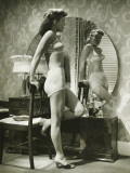 Young Woman in Underwear Standing By Mirror Photographic Print by George Marks