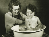 Mother Bathing Daughter (12-18 Months) in Basin Photographic Print by George Marks