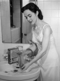 Woman Washing Her Hose at Bathroom Sink Photographic Print by George Marks