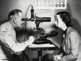 Eye Doctor Examining Patient Photographic Print by George Marks