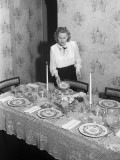 Young Woman Setting Dining Room Table Photographic Print by George Marks