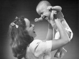 Mother Holding Baby Up in Air Photographic Print by George Marks