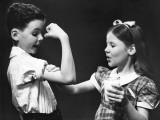 Boy Flexing Muscle For Girl Photographic Print by George Marks