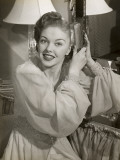Woman Brushes Hair at Vanity Photographic Print by George Marks