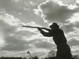 Silhouette of Man Aiming Shotgun Outdoors Photographic Print