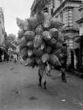 Man Carrying Baskets Photographic Print by Charles Phelps Cushing
