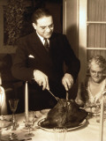 Father Carving Turkey at Table on Christmas Day Photographic Print