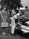 Young Couple Loading Trunk of Car For Picnic Photographic Print