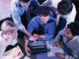 Group of People Gathered Around Laptop Computer, Overhead View Photographic Print
