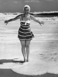 Woman Standing in Shallow Water at Ocean Photographic Print